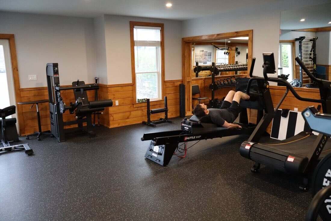 Client training on the Shuttle MVP leg press in the machine room